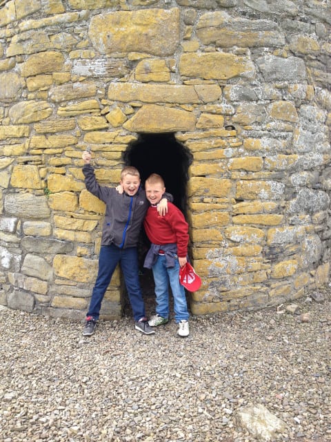 Boys at the foot of the roundtower, Scattery Island